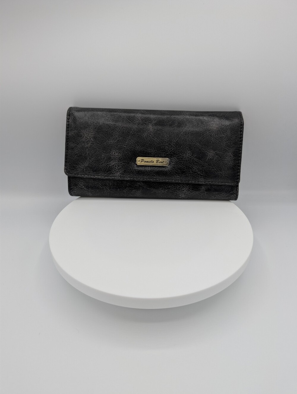 Pomelo Best long trifold wallet in distressed black with pink interior details.
